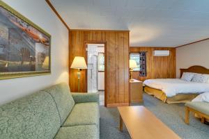 a hotel room with a bed and a couch at Lake Champlain Retreat w/ Dock, Games & More in Willsboro