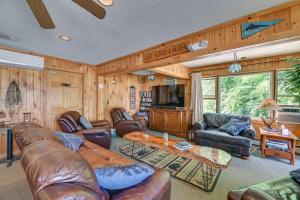 a living room with leather furniture and a flat screen tv at Lake Champlain On-Site! Waterfront Studio w/ Dock in Willsboro