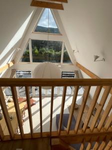 an attic view of a room with a large window at SowiaBrda, domek na wyłączność, Góry Sowie in Rzeczka