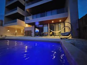 a house with a swimming pool in front of a house at Beachfront , alberca y terraza in Telchac Puerto