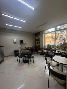 a dining room with tables and chairs in a restaurant at Add Hotéis Center Norte in São Paulo