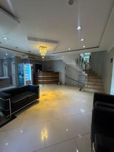 a lobby with couches and stairs in a building at Add Hotéis Center Norte in São Paulo