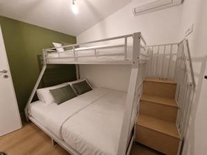 a bedroom with a bunk bed and a staircase at Eiflia- Im Ourtal in Burg-Reuland