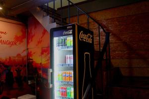 a vending machine filled with bottles of soda at Crew Bangkok Hostel in Bangkok