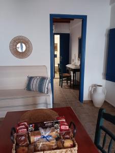 a living room with a table and a couch at On The Waves Balcony in Klima +19 photos
