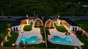 an aerial view of a house with two swimming pools at Highland Hils in Garni