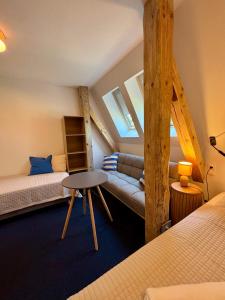 a room with two beds and a couch in it at SZiGET23 in Ábrahámhegy