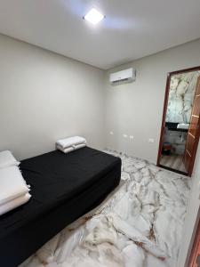 a bedroom with a bed with a marble floor at Vila Bangalô in São José da Coroa Grande +12 photos