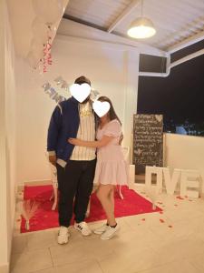 a man and a woman standing in front of a cake at HOTEL GRAND BOUTIQUE in Fusagasuga