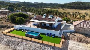 an aerial view of a house with a swimming pool at Monte da Caniveta - Casa do Avô in São Luis