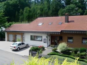 a house with a car parked in the driveway at Gästehaus Renate in Lauf