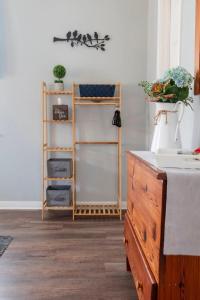 a bedroom with a bed and a dresser and a shelf at Cozy Cottage in Waco +24 photos