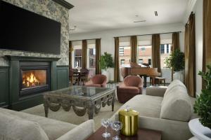 a living room with a couch and a fireplace at Davenport Hotel, Autograph Collection in Spokane