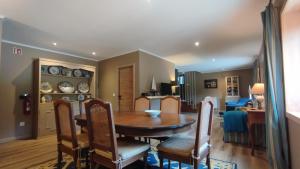 a dining room and living room with a table and chairs at Quinta de Linhares in Oliveira