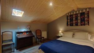 a bedroom with a bed and a television in it at Quinta de Linhares in Oliveira