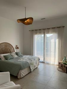 a bedroom with a bed and a large window at Gîte du Grand Frêne in Nérac +8 photos