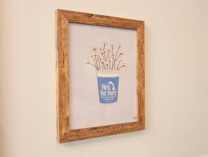 a picture of a framed picture of a pot of flowers at Tiny Tarheel Cozy Retreat Near UNC-Tiny House in Chapel Hill +35 photos