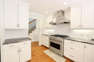 a kitchen with white cabinets and a stove top oven at Lg Pool House w Hot Tub Central to RTPPool OPEN in Durham