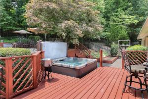 a hot tub sitting on a wooden deck at Lg Pool House w Hot Tub Central to RTPPool OPEN in Durham
