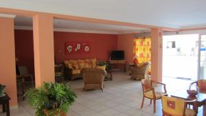 a living room with a couch and chairs at Apartamentos Amazonas in Playa del Ingles