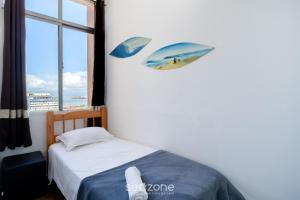 a bedroom with a bed with two umbrellas on the wall at Apt in Downtown Floripa CAT0905 in Florianópolis