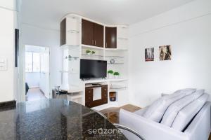 a living room with a glass table and a tv at Apt in Downtown Floripa CAT0905 in Florianópolis