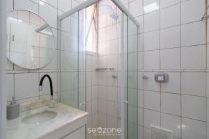 a bathroom with a sink and a shower with a mirror at Apt in Downtown Floripa CAT0905 in Florianópolis +5 photos
