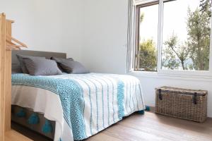a white bedroom with a bed and a window at Villa Francesca Toscolano in Toscolano Maderno
