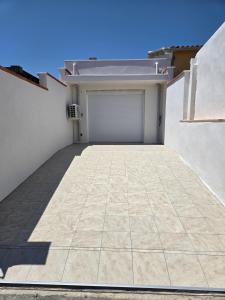 a garage with a garage door on the side of a building at Le Canetois in Canet-en-Roussillon