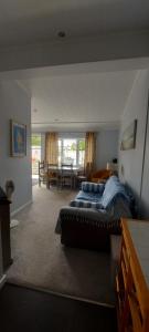 a bedroom with a bed and a dining room at Overlooking the Norfolk Broads in Carlton Colville +12 photos