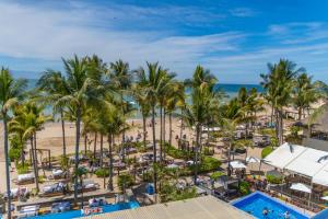 an aerial view of a resort with palm trees and a beach at Friendly Fun Vallarta Different Experiences - All Inclusive in Puerto Vallarta