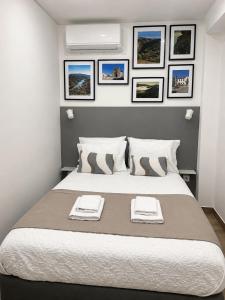 a bedroom with a large bed with two towels on it at Casas da Barca in Vila Nova de Foz Coa