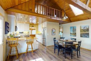 a kitchen and dining room with a table and chairs at Brier Escape in Bass Lake