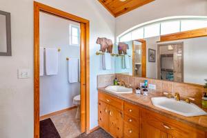 a bathroom with two sinks and a mirror at Brier Escape in Bass Lake +46 photos