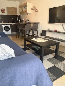 a room with a bed and a table and a kitchen at Nenas house in Porto Rafti