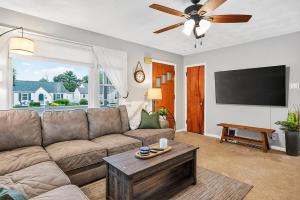 a living room with a couch and a flat screen tv at Cozy Corner in Terre Haute