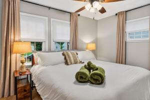 a bedroom with a white bed with towels on it at Cozy Corner in Terre Haute