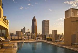 a swimming pool on top of a building with a city skyline at SE Furnished Apartment in Atlanta