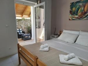 a bedroom with a large bed with towels on it at Fiore apartment & room in Krk