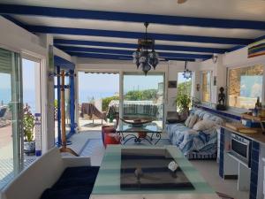 a living room with a blue and white ceiling at Chalet, breathtaking sea view with large jacuzzi in Almuñécar