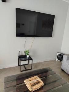 a living room with a flat screen tv on a wall at Casa Reyna in Hacienda Cienguilla