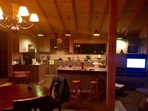a kitchen with a table and chairs and a dining room at Casa Monita in El Quisco +6 photos