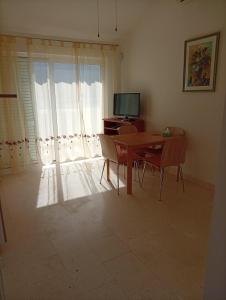 a living room with a table and a television at Dobrila in Slano