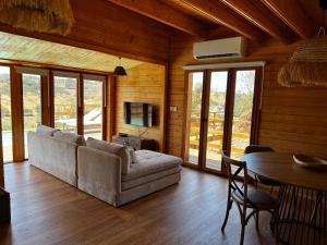 a living room with a couch and a table at Corvatos Casas do Monte in Almodôvar