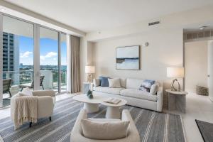 a living room with white furniture and large windows at Luxury Ocean View 2BR in Riviera Beach +51 photos