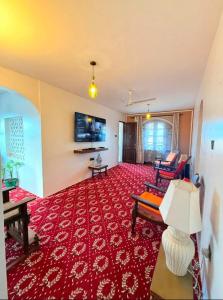 a living room with a red carpet at Bakarani in Mombasa