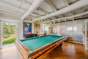 a pool table in a living room with a ceiling at Villa CALVI Lago Maggiore in Premeno