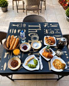 a blue table with plates of food on it at Royal Moses Pyramids View Hotel in Cairo