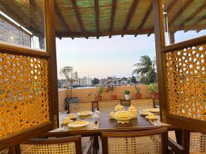 a wooden table with plates of food on a balcony at Bakarani in Mombasa