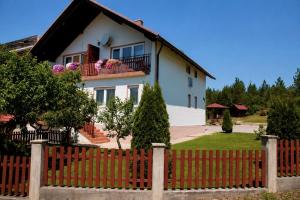 a house with a red fence at Guest House Kovačević in Korenica